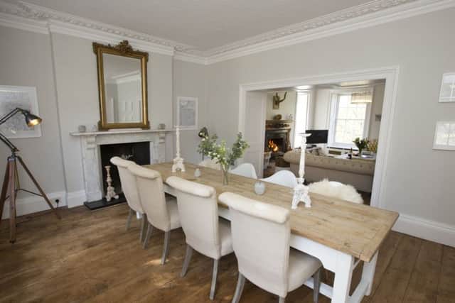 The dining room with antique Irish table and a collection of traditional chairs teamed with Eames chairs.