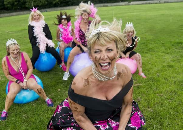 Getting muddy:  A team of glamourous business women, led by Huddersfield cancer survivor Mandy Taylor are raising cash for Cancer Research UK