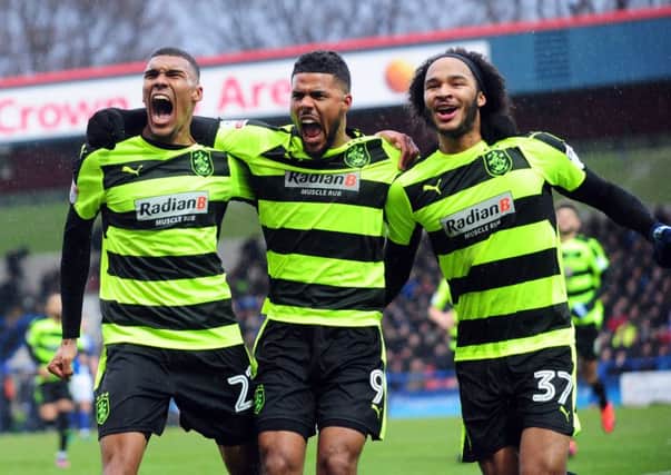 Izzy Brown, far right, celebrates a goal at Rochdale with then Huddersfield team-mates Collin Quaner, left, and Elias Kachunga. Picture: Simon Hulme