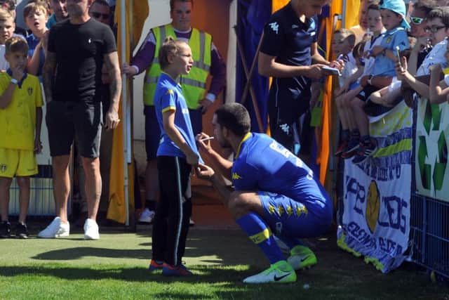 Guiseppe Bellusci signs a fan's shirt at half-time during Saturday's pre-season friendly win at Guiseley. Picture: Tony Johnson
