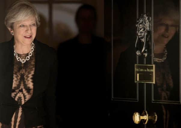 Theresa May at 10 Downing Street, but how many marks out of 10 does she deserve for the first year of her premiership?