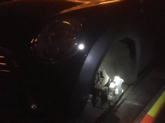 The car with its missing wheel. Photo: West Yorkshire Police