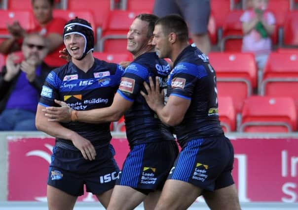 Hiitting their stride: From left, Leeds Rhinos trio Jack Walker, Danny McGuire and Ryan Hall celebrate the win at Salford. (Picture: Tony Johnson)