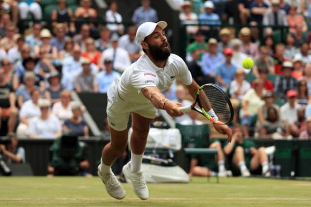 Benoit Paire stretches to make a volleyed return against Andy Murray at Wimbledon. Picture: Adam Davy/PA