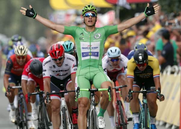 Germany's Marcel Kittel, wearing the best sprinter's green jersey celebrates as he crosses the finish line to win the tenth stage of the Tour de France cycling race over 178 kilometers (110.6 miles).
