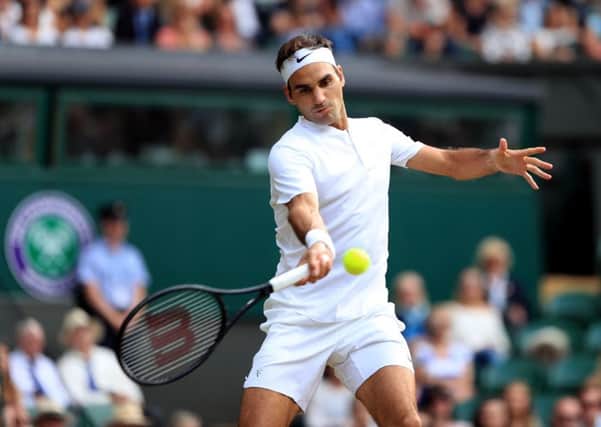 Roger Federer in action against Grigor Dimitrov on day seven of the Wimbledon Championships at The All England Lawn Tennis and Croquet Club, Wimbledon.  PRESS ASSOCIATION Photo. Picture date: Monday July 10, 2017.