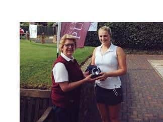 Pannal's Olivia Jackson receives a hole-in-one glass memento from Pleasington Putter organiser Beth Brown.