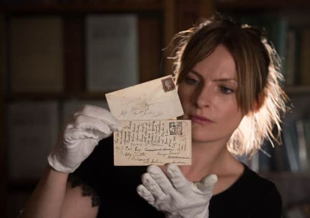 Curator Sarah Laycock with an envelope addressed by Charlotte BrontÃ«. PIC: Charlotte Graham/Guzelian