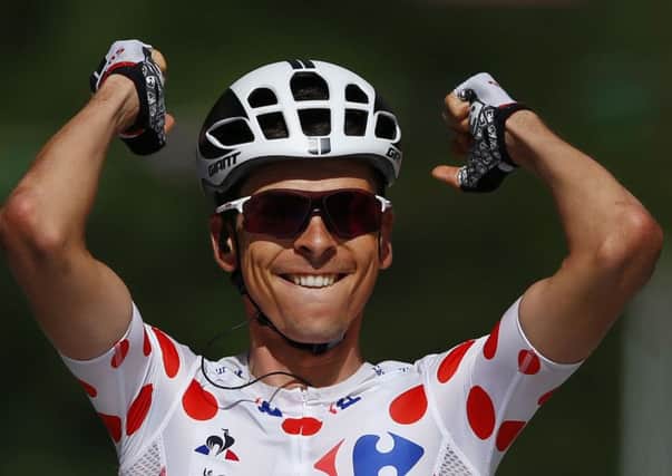France's Warren Barguil, wearing the best climber's dotted jersey, celebrates a she crosses the finish line ahead of third placed Spain's Alberto Contador, rear, to win the thirteenth stage of the Tour de France . (AP Photo/Peter Dejong)