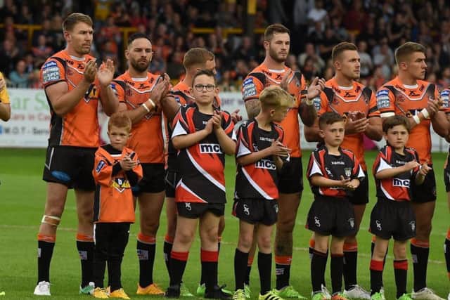 Castleford Tigers' players engage in a minute's applause for Stanley Rangers player Evan Hawksworth, who passed away after suffering a head injury in a game earlier this week. Picture: Matthew Merrick/RL PHOTOS