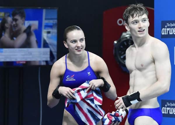 Second placed Lois Toulson and Matthew Lee of Great Britain watch the scoreboard at the Swimming World Championships 2017 in Duna Arena in Budapest, Hungary. (Tibor Illyes/MTI via AP)