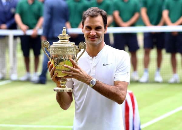 Roger Federer with the trophy after beating Marin Cilic at Wimbledon. Picture: Gareth Fuller/PA
