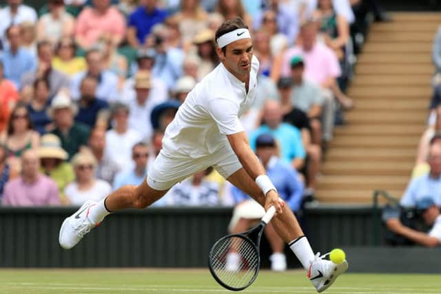 Roger Federer stretches to make a forehand drop shot against Marin Cilic in Sunday's final at Wimbledon. Picture: Adam Davy/PA