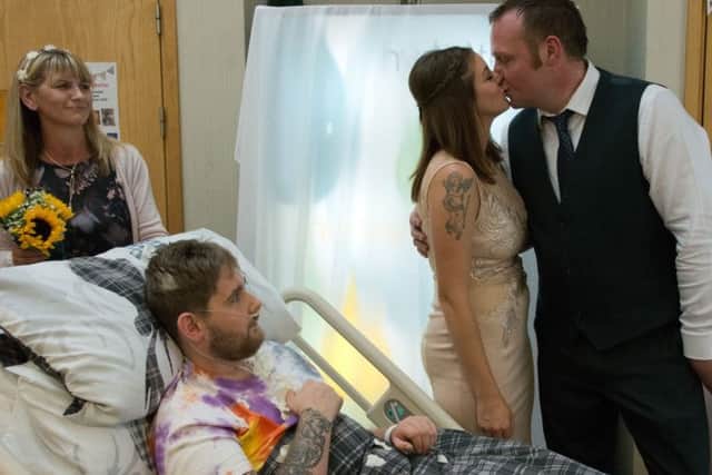 Amie and David in the 'wedding' ceremony organise by hospital staff and watched by her brother Andrew