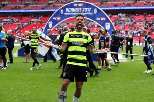 Despite being on crutches, Huddersfield Town's Tommy Smith celebrates after winning the Championship play-off final at Wembley. Picture: Nick Potts/PA