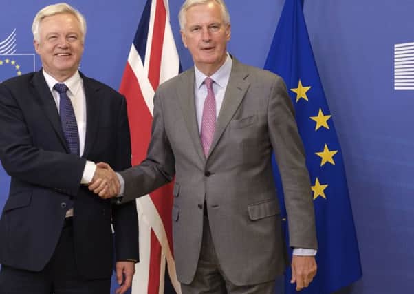 EU chief Brexit negotiator Michel Barnier, right, poses with British Secretary of State David Davis for a photo ahead of Brexit talks in Brussels. (AP).