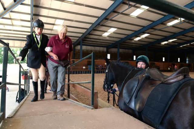 Anna Lickley, who is deaf and blind and this weekend competed in the  national RDA (Riding for the Disabled Association) championships, pictured being help to mount horse Robbie at the St Ives Riding for the Disabled, Bingley.