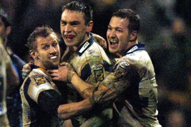 Rob Burrow celebrates a try against Hull FC with team-mate Danny McGuire and Kevin Sinfield.