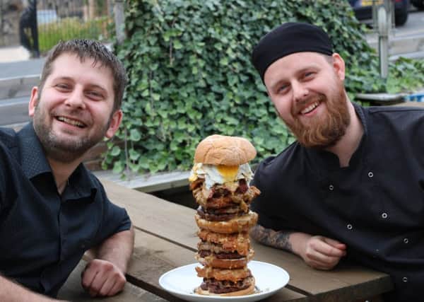 the big eat: Simon Robinson and Ben Jones, directors and co-owners of Holy Molys Deep South Kitchen, with with one of their 8lb challenge gator burgers.
