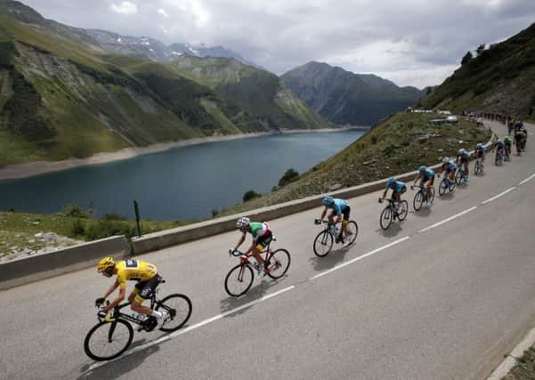 Britain's Chris Froome, wearing the overall leader's yellow jersey, is followed by Italy's Fabio Aru as they climb Croix de Fer pass.