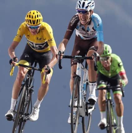 Chris Froome, left, Rigoberto Uran, right, and Romain Bardet cross the finish line during the 18th stage of the Tour de France. Picture: AP/Christophe Ena.