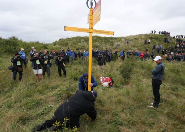 Rory McIlroy waits for a sign to be moved so he can play a shot on the 15th hole during the second round of the Open at Royal Birkdale (Picture: Richard Sellers/PA Wire).