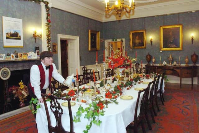 Harry Fisher  Head of Front of House at Lotherton Hall  putting the final touches to the Christmas table decorated by his wife Joyce Fisher in the Dining Room at Lotherton Hall.