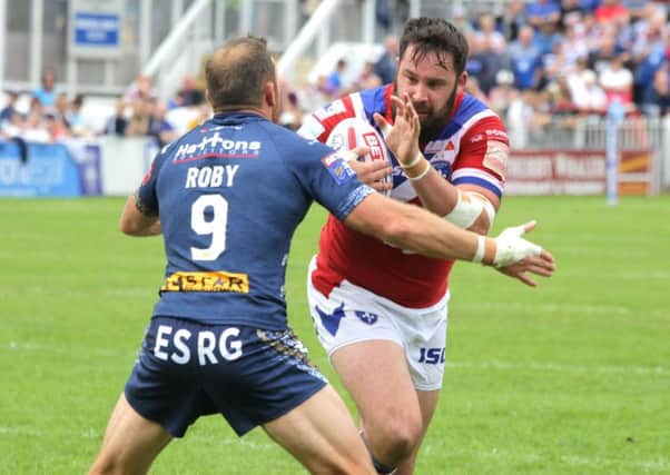 Craig Huby tries to get past James Roby.