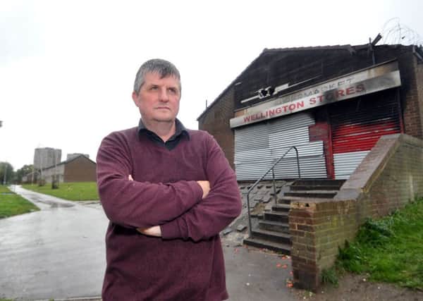 Bill Graham pictured last October by the burnt out Wellington Stores n the New Wortley estate. Wellington Stores has since been demolished and new housing is planned at the site.