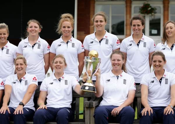 The England women cricket team pose with the World Cup trophy.