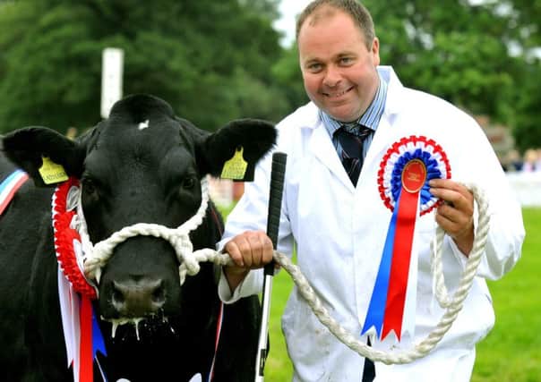 Dylan Townend from Broughton near Malton with Clifftown Ladyluck, a British Blue heifer that was named the Supreme Champion beef animal at Ryedale Show. Picture by Gary Longbottom.