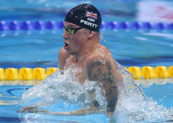 Britain's Adam Peaty swims when setting a new world record in a men's 50-meter breaststroke.
