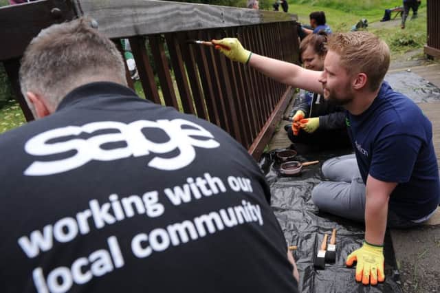 Volunteers from software firm Sage UK take part in a clean up of Monkton Dene, Jarrow.