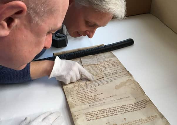 Carolyn Dalton and Charles Kelham, Doncaster's Heritage Services looking at 13th Century Conisbrough Court Roll