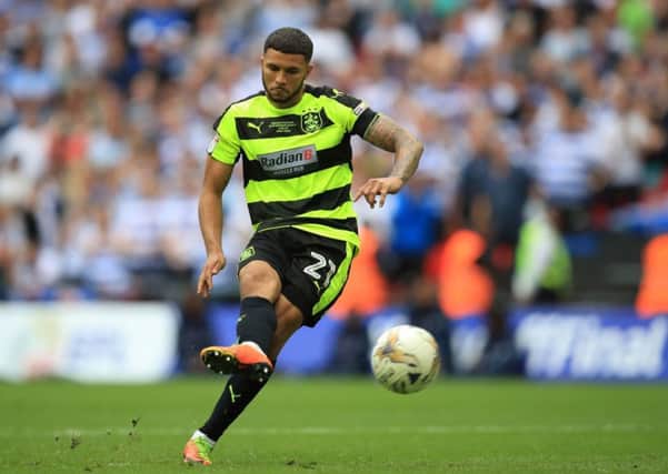Huddersfield Town's Nahki Wells scores from the penalty spot during the Sky Bet Championship play-off final at Wembley Stadium, London.