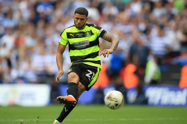 Huddersfield Town's Nahki Wells scores from the penalty spot during the Sky Bet Championship play-off final at Wembley Stadium, London.