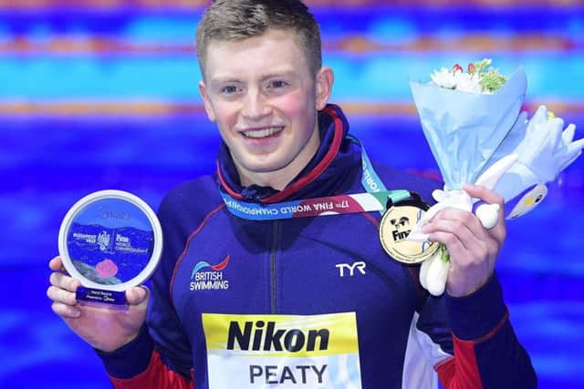 Gold medal winner Adam Peaty of Britain on the podium during the awarding ceremony of men's 50m breaststroke final of the World Aquatics Championships in the Duna Arena in Budapest (Tamas Kovacs/MTI via AP)