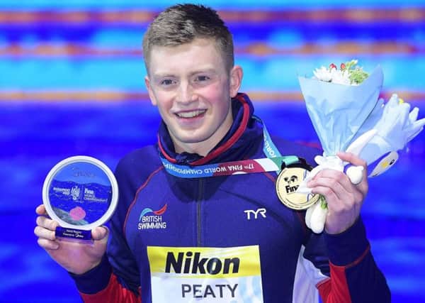 Gold medal winner Adam Peaty of Britain on the podium during the awarding ceremony of men's 50m breaststroke final of the World Aquatics Championships in the Duna Arena in Budapest (Tamas Kovacs/MTI via AP)