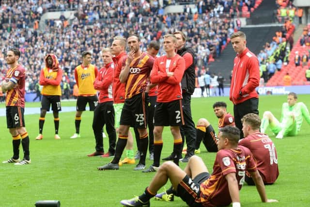 Bradford City's players watch on as Millwall collect the League One play-off final trophy.  Picture: Bruce Rollinson