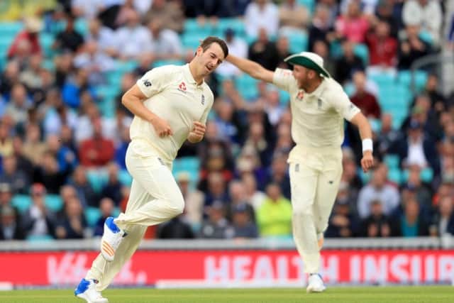 England's Toby Roland-Jones celebrates after bowling out South Africa's Hashim Amla. Picture: Adam Davy/PA