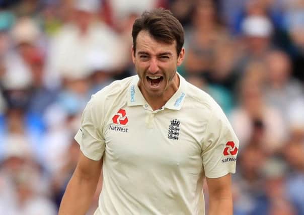 Got him: England's Toby Roland-Jones celebrates taking his fifth wicket, that of South Africa's Temba Bavuma.