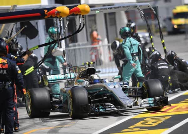 Team mechanics change tyres on Lewis Hamiltons Mercedes during the Hungarian Grand Prix (Picture: Zsolt Czegled/AP).