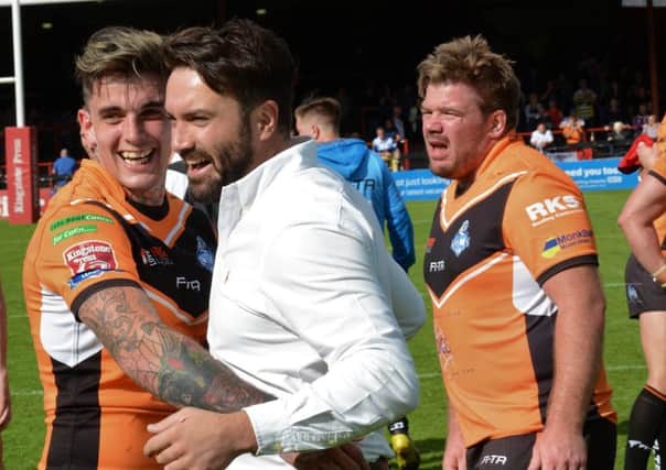 York City Knights coach James Ford, right, gives full-back Ash Robson a hug after Sundays famous win over full-time Toronto Wolfpack.