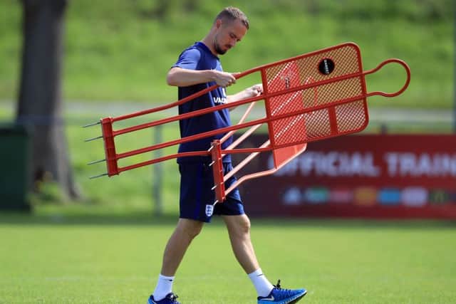 England head coach Mark Sampson sorts out some equipment in training ahead of Thursday's Euro 2-17 semi-final with Holland (PIcture: PA)