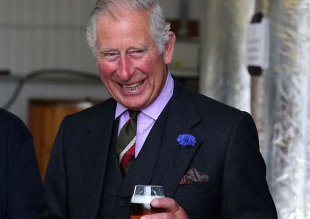The Prince of Wales, known as the Duke of Rothesay while in Scotland, tries a pint a pint of Swelkie Golden Ale during a visit to the John O'Groats Brewery in John O'Groats