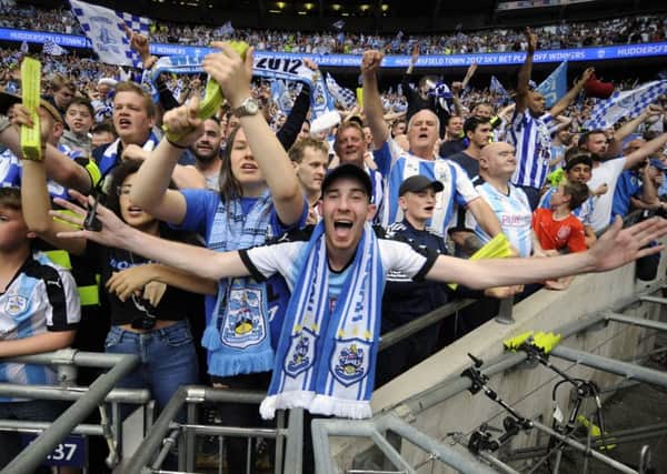 Huddersfield Town fans celebrate promotion to the Premier League via the play-offs. Picture by Simon Hulme