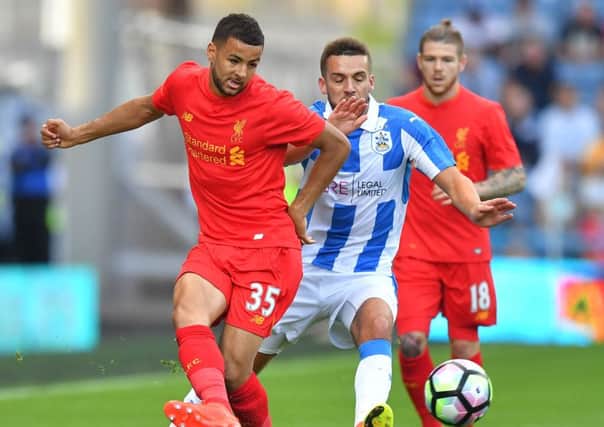 Rebuilding: Hull signing Kevin Stewart, holding off Huddersfield Town's Tommy Smith, had little chance to shine at Liverpool