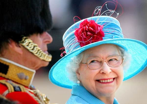 The Queen smiling with the Duke of Edinburgh on Horse Guards Parade