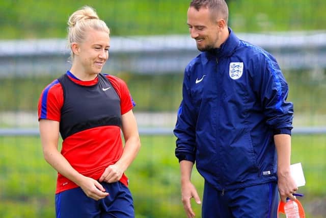 England's Laura Bassett (left) and England manager Mark Sampson, right, chats with Laura Bassett during a training session on Wednesday. Picture: Mike Egerton/PA