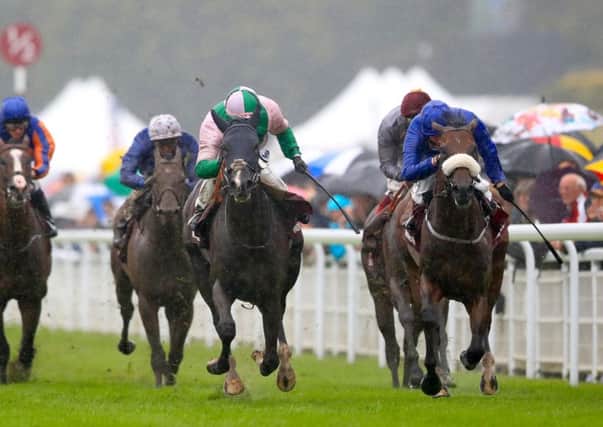 Here Comes When ridden by jockey Jim Crowley (centre) on his way to winning the Qatar Sussex Stakes from Ribchester and William Buick, right, at Goodwood on Wednesday. Picture: John Walton/PA.